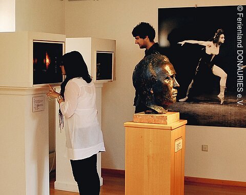 Zwei Besucher betrachten die Schaukästen in der Werner-Egk-Begegnungsstätte