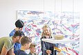 Eine Familie macht eine Führung im KunstMuseum und sieht sich bestimmte Gesteine an.